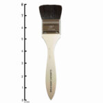 Japan Brush 1 and 1/2 inch. A flat bundle of smooth and black goat hair with a chrome-plated brass ferrule that fastens the hair to a lacquered wooden handle.