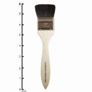 Japan Brush 1 and 1/2 inch. A flat bundle of smooth and black goat hair with a chrome-plated brass ferrule that fastens the hair to a lacquered wooden handle.