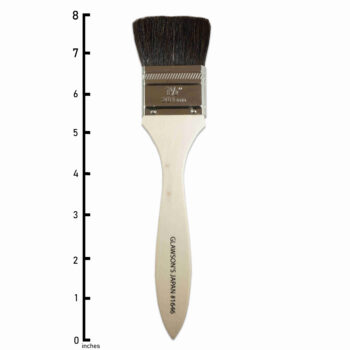Japan Brush 1 and 1/2 inch. A flat bundle of smooth and black goat hair with a chrome-plated brass ferrule that fastens the hair to a lacquered wooden handle.